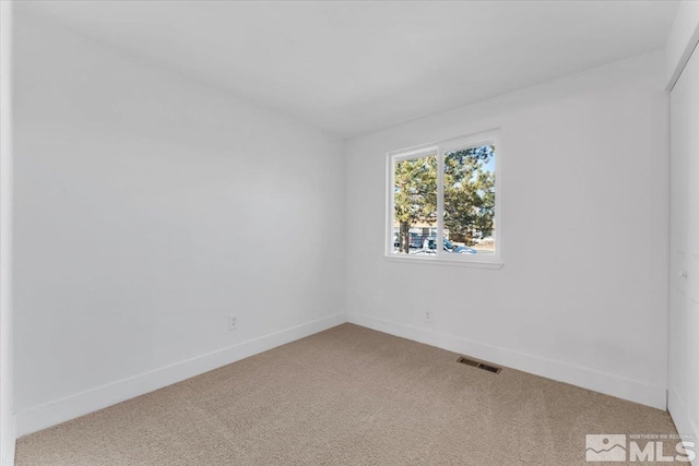 unfurnished room featuring carpet flooring