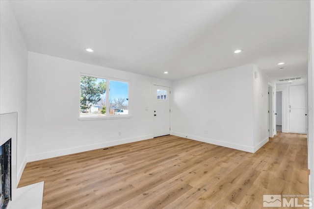 unfurnished living room with light hardwood / wood-style flooring