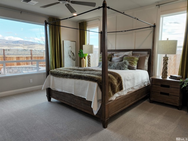 bedroom with ceiling fan, carpet, and a mountain view