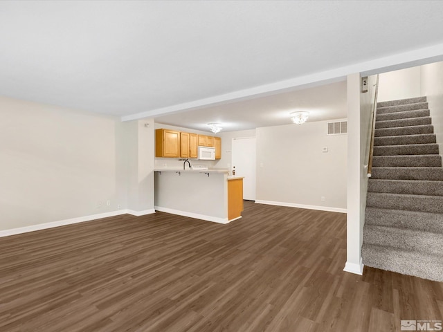 unfurnished living room featuring dark wood-type flooring