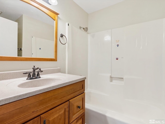 bathroom with washtub / shower combination and vanity