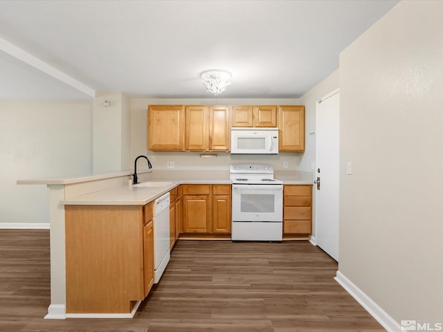 kitchen with sink, dark wood-type flooring, kitchen peninsula, white appliances, and light brown cabinetry