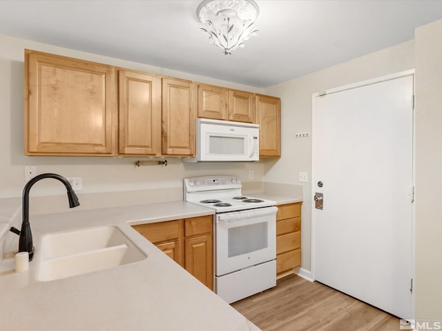 kitchen with white appliances, sink, light brown cabinets, light hardwood / wood-style flooring, and a notable chandelier