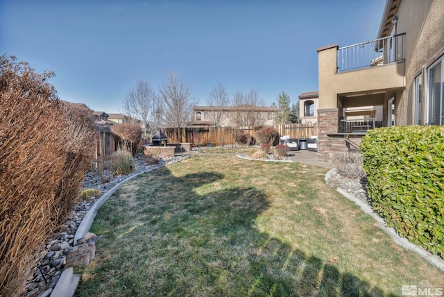 view of yard with a patio and a balcony