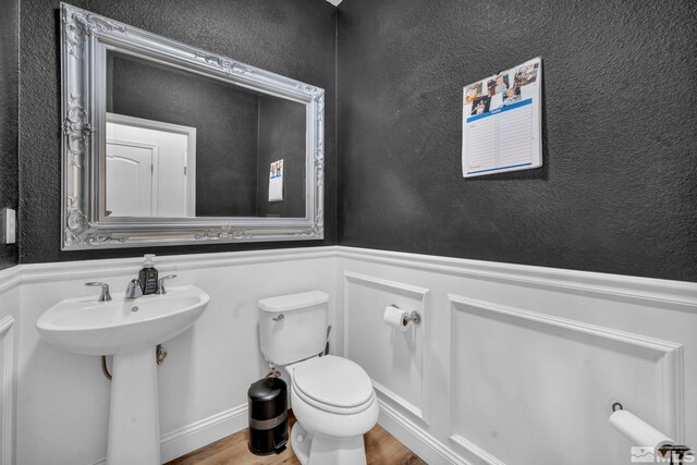 bathroom featuring hardwood / wood-style floors, toilet, and sink