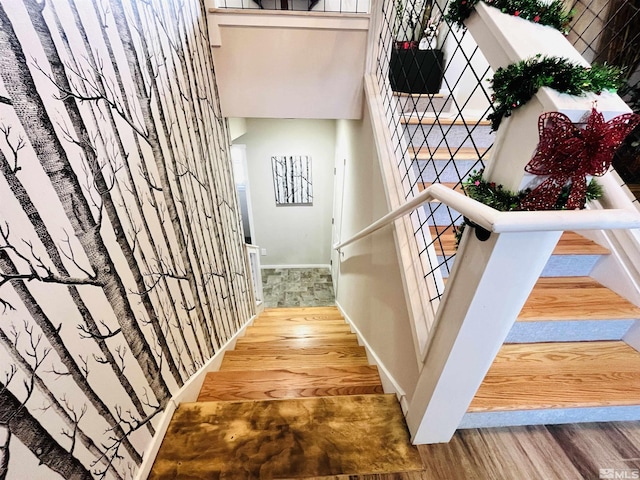 stairs featuring wood-type flooring