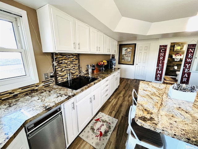 kitchen with dark hardwood / wood-style floors, dishwasher, white cabinetry, and light stone counters