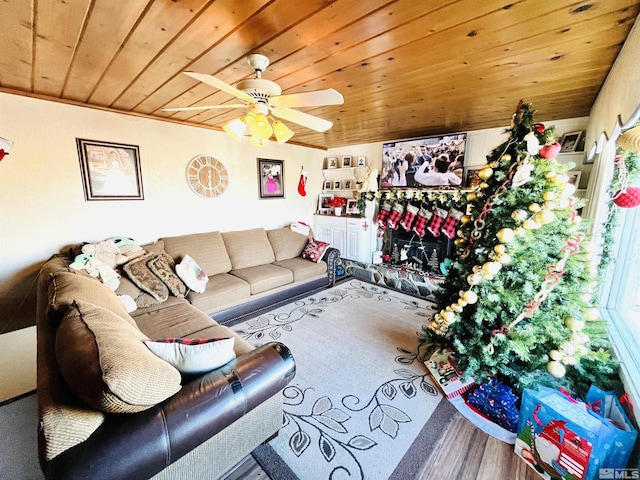 living room with ceiling fan, hardwood / wood-style floors, and wood ceiling