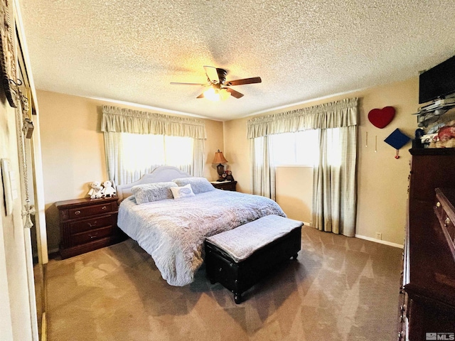 bedroom with carpet flooring, ceiling fan, and a textured ceiling