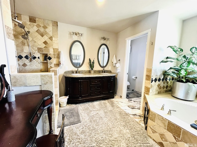 full bathroom featuring vanity, independent shower and bath, and toilet