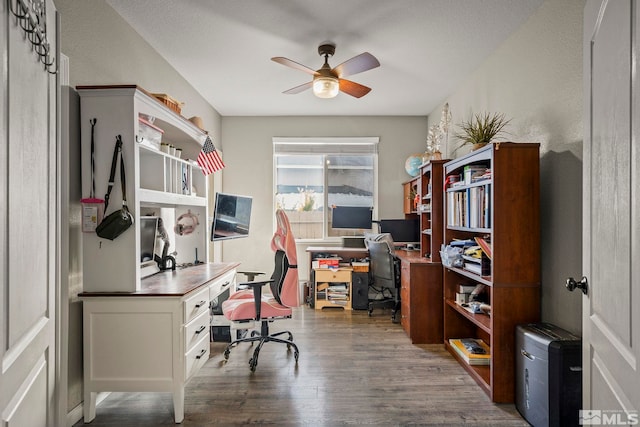 home office with ceiling fan and dark wood-type flooring