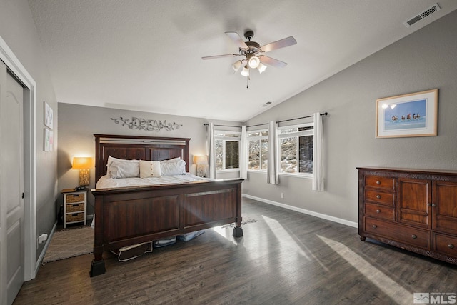 bedroom with a closet, vaulted ceiling, ceiling fan, and dark wood-type flooring