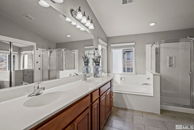 bathroom featuring vaulted ceiling and shower with separate bathtub