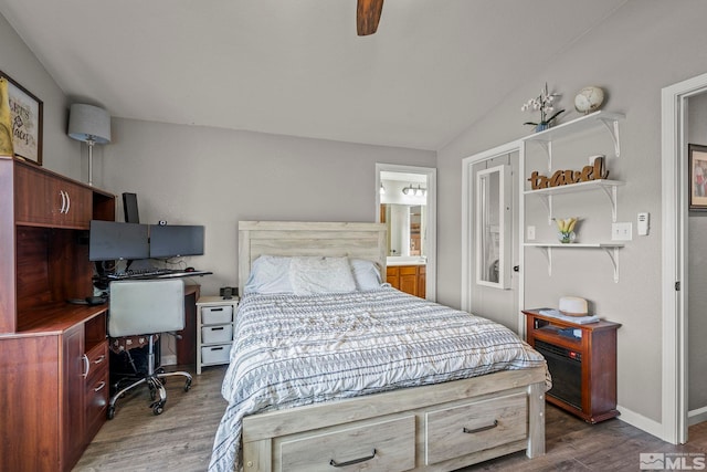 bedroom with connected bathroom, ceiling fan, dark wood-type flooring, and lofted ceiling