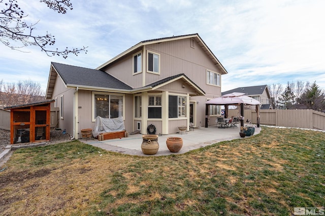 rear view of house with a lawn, a gazebo, and a patio