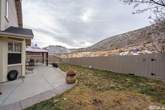 view of yard featuring a gazebo, a mountain view, and a patio