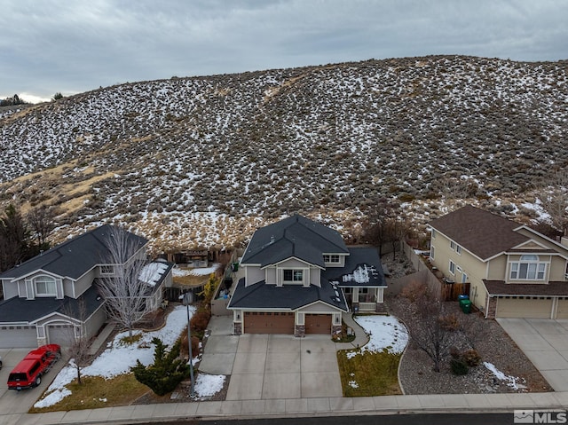 snowy aerial view featuring a mountain view