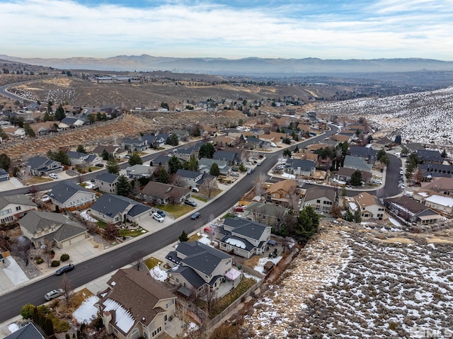 snowy aerial view featuring a mountain view