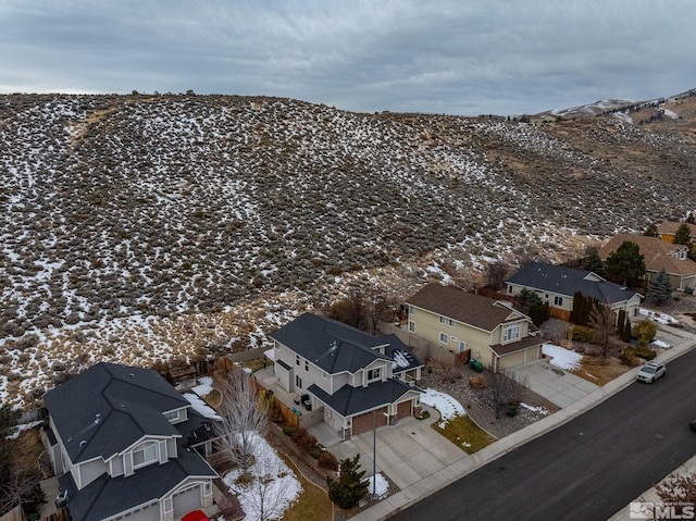 snowy aerial view featuring a mountain view