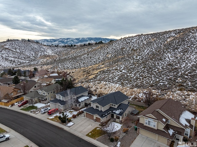 snowy aerial view featuring a mountain view