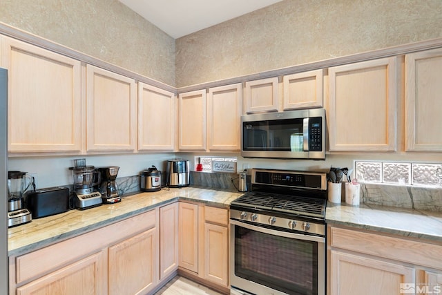 kitchen featuring light brown cabinets and stainless steel appliances