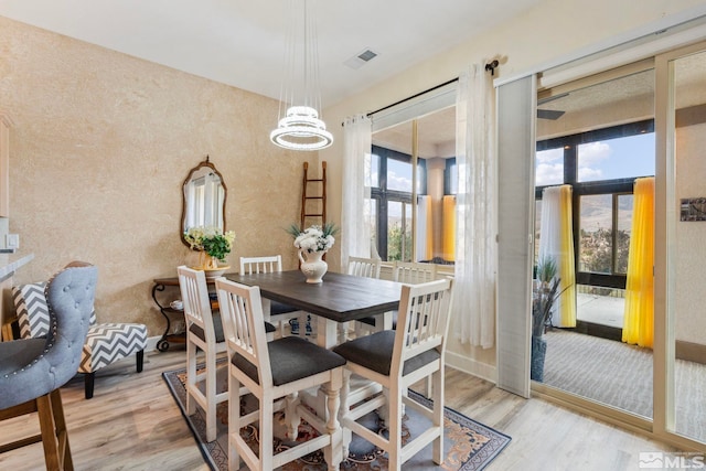 dining room featuring light hardwood / wood-style flooring and a notable chandelier