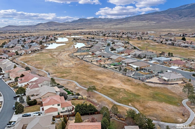 drone / aerial view featuring a water and mountain view