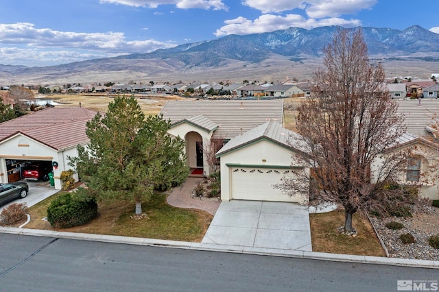 single story home with a mountain view and a garage