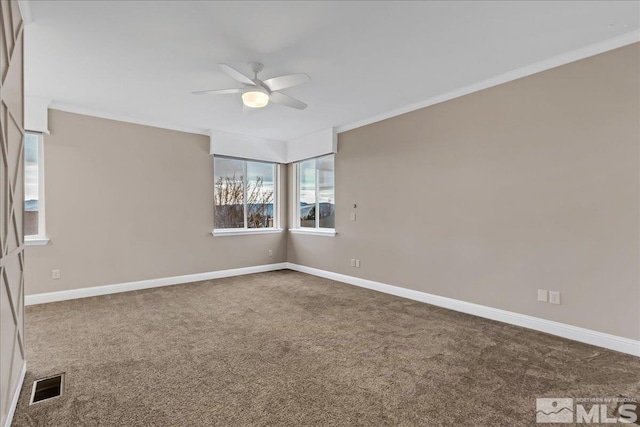 carpeted empty room with ceiling fan and crown molding