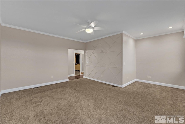 spare room featuring carpet, ceiling fan, and crown molding