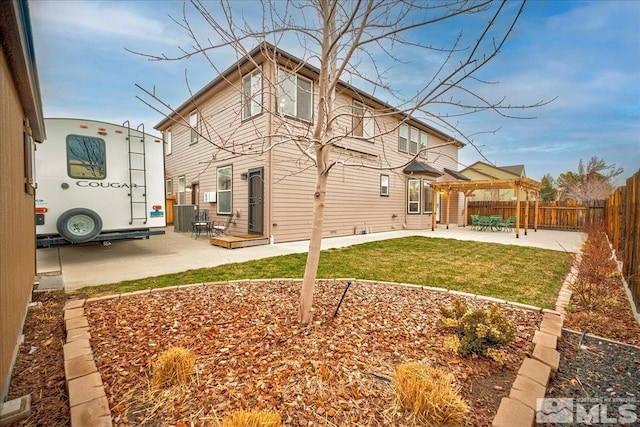 back of property with a patio area and a yard