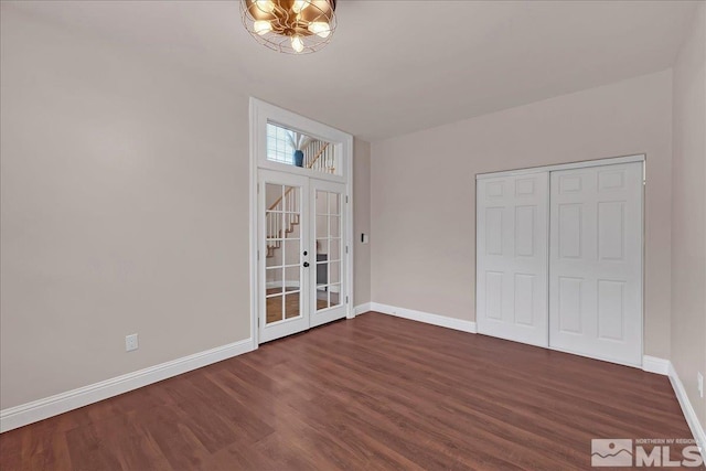 unfurnished bedroom with dark hardwood / wood-style flooring and a closet