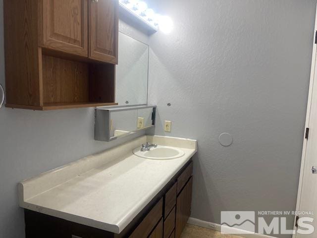 bathroom with vanity and tile patterned floors