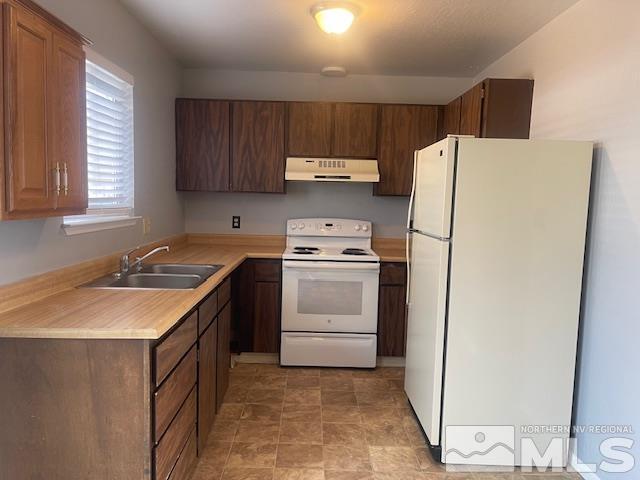 kitchen with sink and white appliances