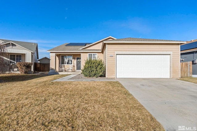 ranch-style house featuring a porch, a garage, a front lawn, and solar panels