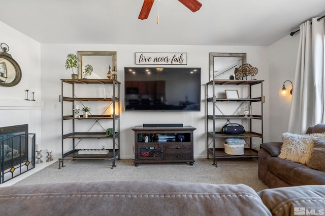 living room featuring ceiling fan, carpet, and a fireplace