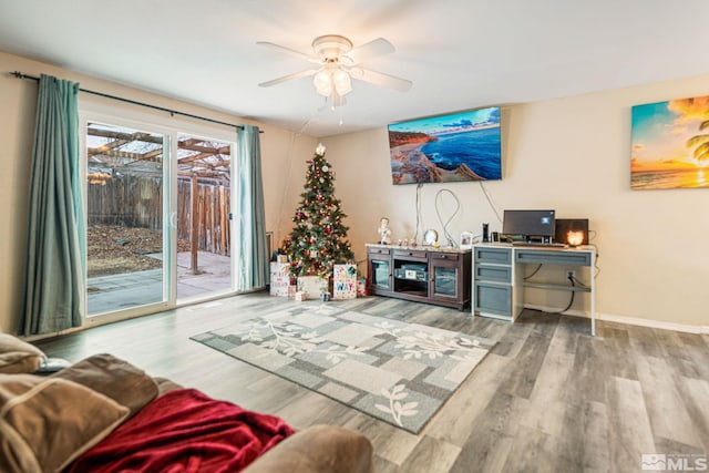 living room featuring hardwood / wood-style flooring and ceiling fan