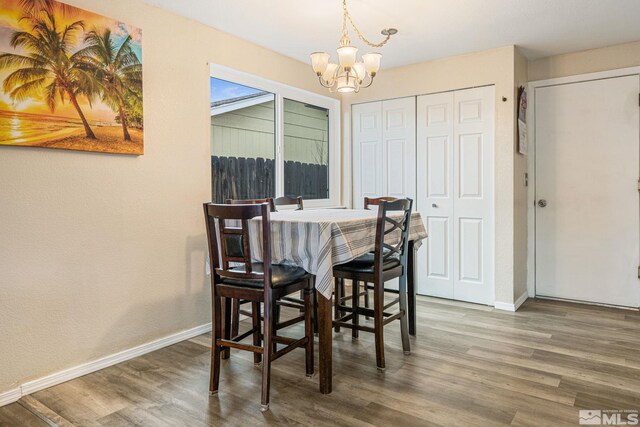 dining area featuring a chandelier and wood-type flooring