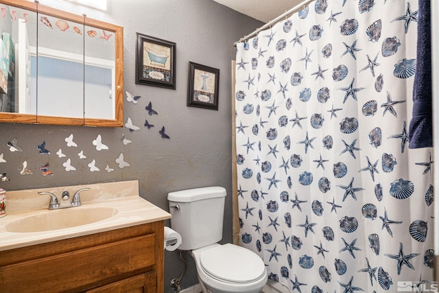 bathroom featuring vanity, toilet, and curtained shower