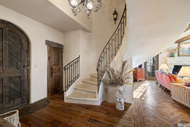 foyer entrance with a chandelier and hardwood / wood-style flooring