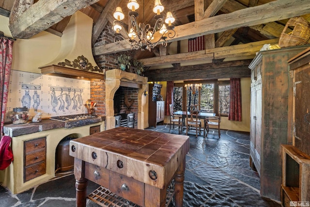 kitchen with decorative light fixtures, beam ceiling, high vaulted ceiling, and a chandelier