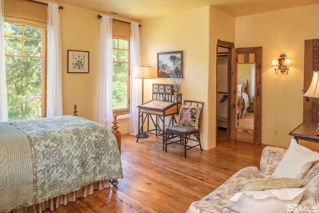 bedroom featuring light hardwood / wood-style floors and multiple windows