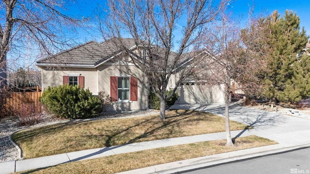 view of front of home with a garage and a front lawn