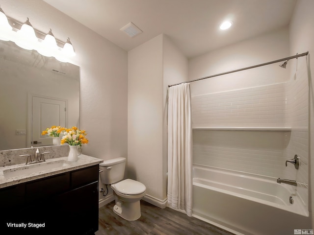 full bathroom featuring hardwood / wood-style flooring, shower / bath combo, toilet, and vanity