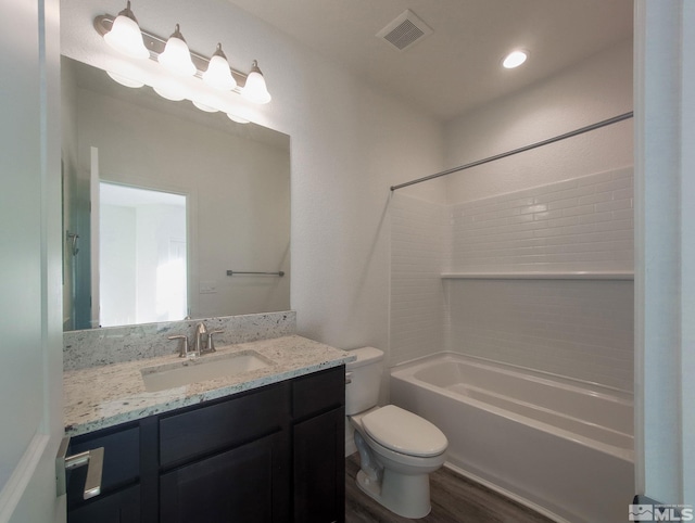 full bathroom featuring hardwood / wood-style floors, vanity, shower / bathtub combination, and toilet