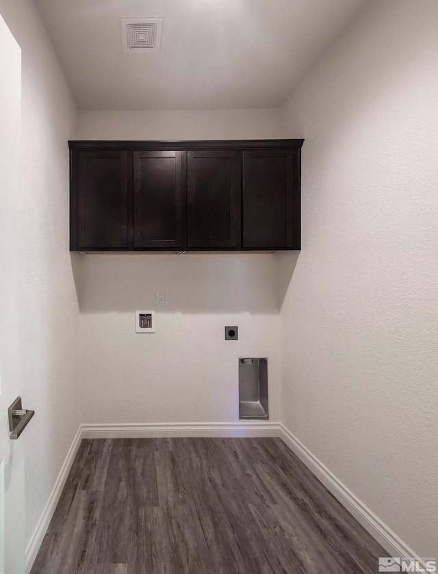 washroom with cabinets, dark wood-type flooring, washer hookup, and hookup for an electric dryer