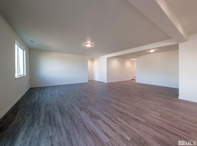 unfurnished room featuring dark hardwood / wood-style flooring