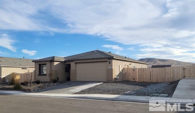 view of front of property with a mountain view and a garage