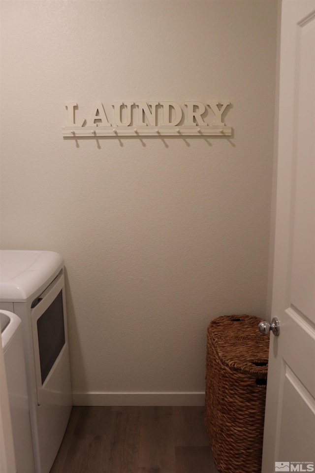 laundry room with dark hardwood / wood-style flooring and independent washer and dryer