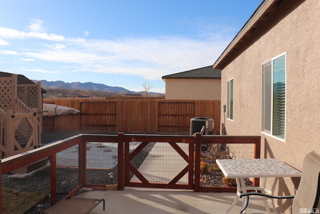 exterior space featuring central AC, a mountain view, and a patio area